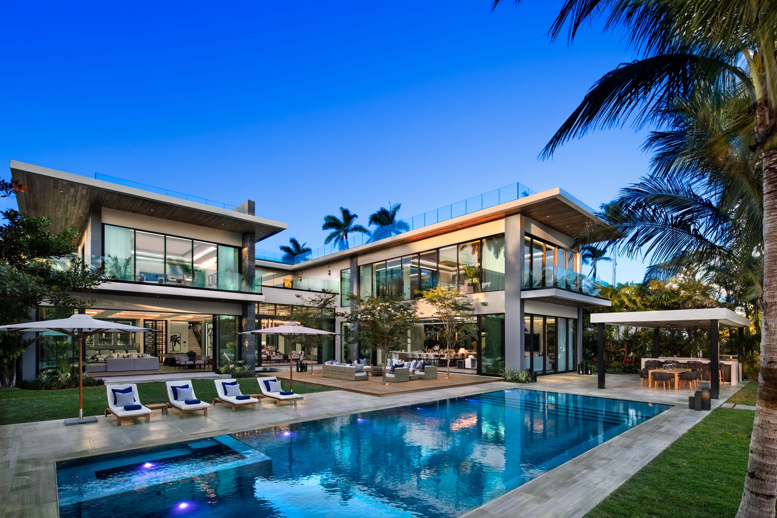 Two-story contemporary custom home by Bart Reines Luxury Homebuilder, with a pool, spa, lounge chairs and covered terraces